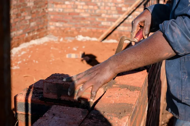 Bedding a brick into fresh mortar