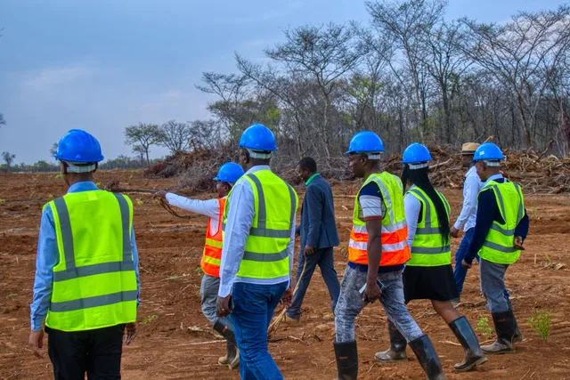 Team crossing the cleared development site